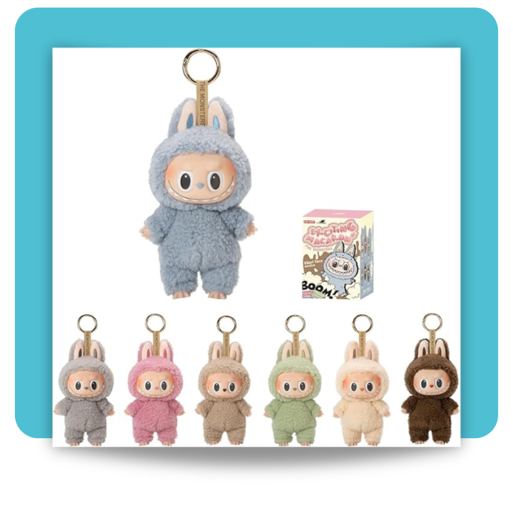 A plush-textured 17 cm keychain figure of Labubu from POP MART’s “Tasty Macarons” series, dressed in a soft pastel-blue onesie with bunny ears and a glossy vinyl face showcasing Labubu’s signature wide eyes and toothy grin, mounted on a gold-tone metal keyring alongside its pastel-themed blind-box packaging featuring whimsical macaron-inspired illustrations