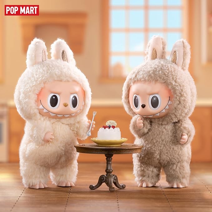 POP MART The Monsters Tasty Macarons figures in cream bunny suits sharing a dessert in a cozy kitchen scene.