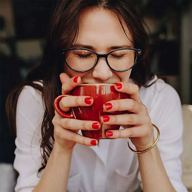 Woman enjoying fresh brewed coffee with rich aroma and smooth taste

