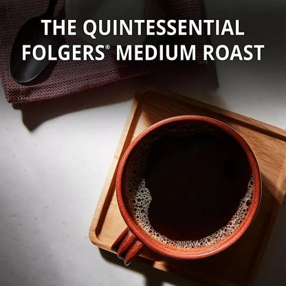 Top view of a cup of black coffee on a wooden tray with text reading “The Quintessential Folgers Medium Roast”

