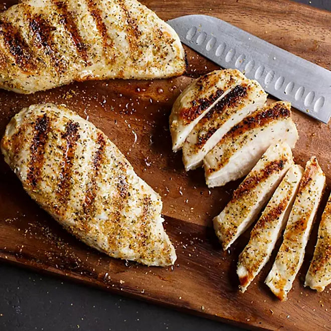 Grilled chicken breasts seasoned with Montreal Chicken blend on wooden board

