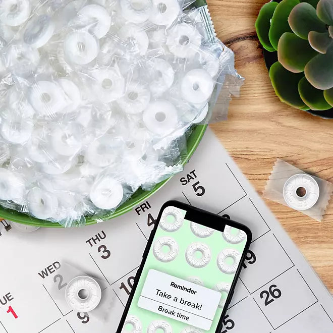 "Life Savers Wint-O-Green Mints in a green bowl placed on a table."