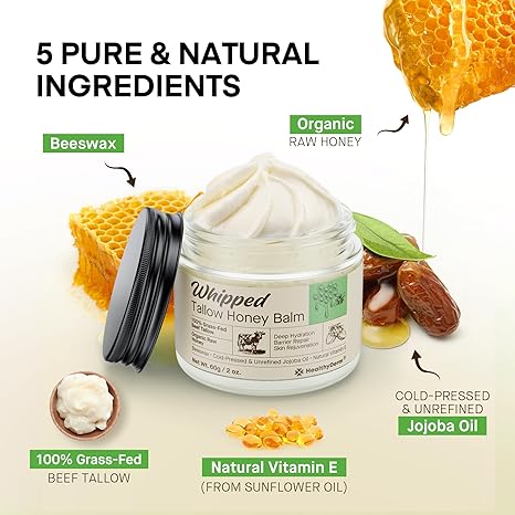 Beef tallow honey balm surrounded by natural ingredients including raw honey, beeswax, jojoba oil, grass-fed tallow, and vitamin E capsules.

